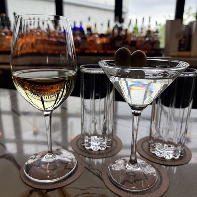 Dirty martini with olives and a wine glass on the upstairs bar